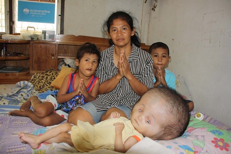 The Oumprasert family prays for a better future for young Nopakorn.
